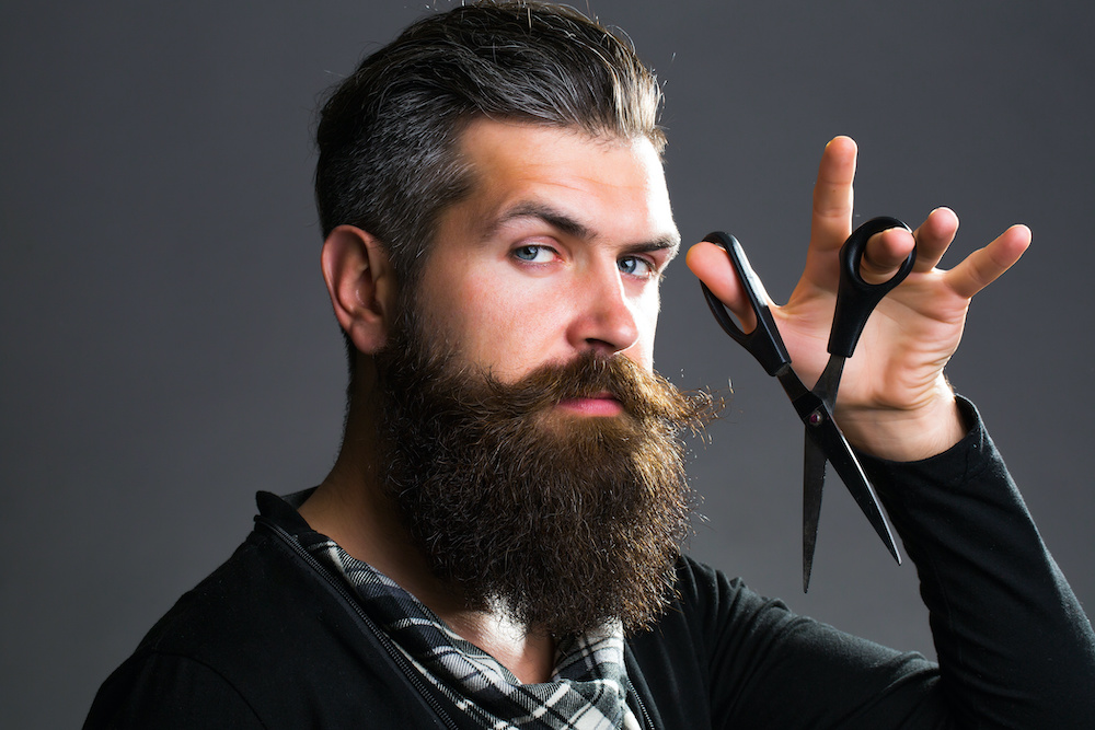 bearded man with barber scissors